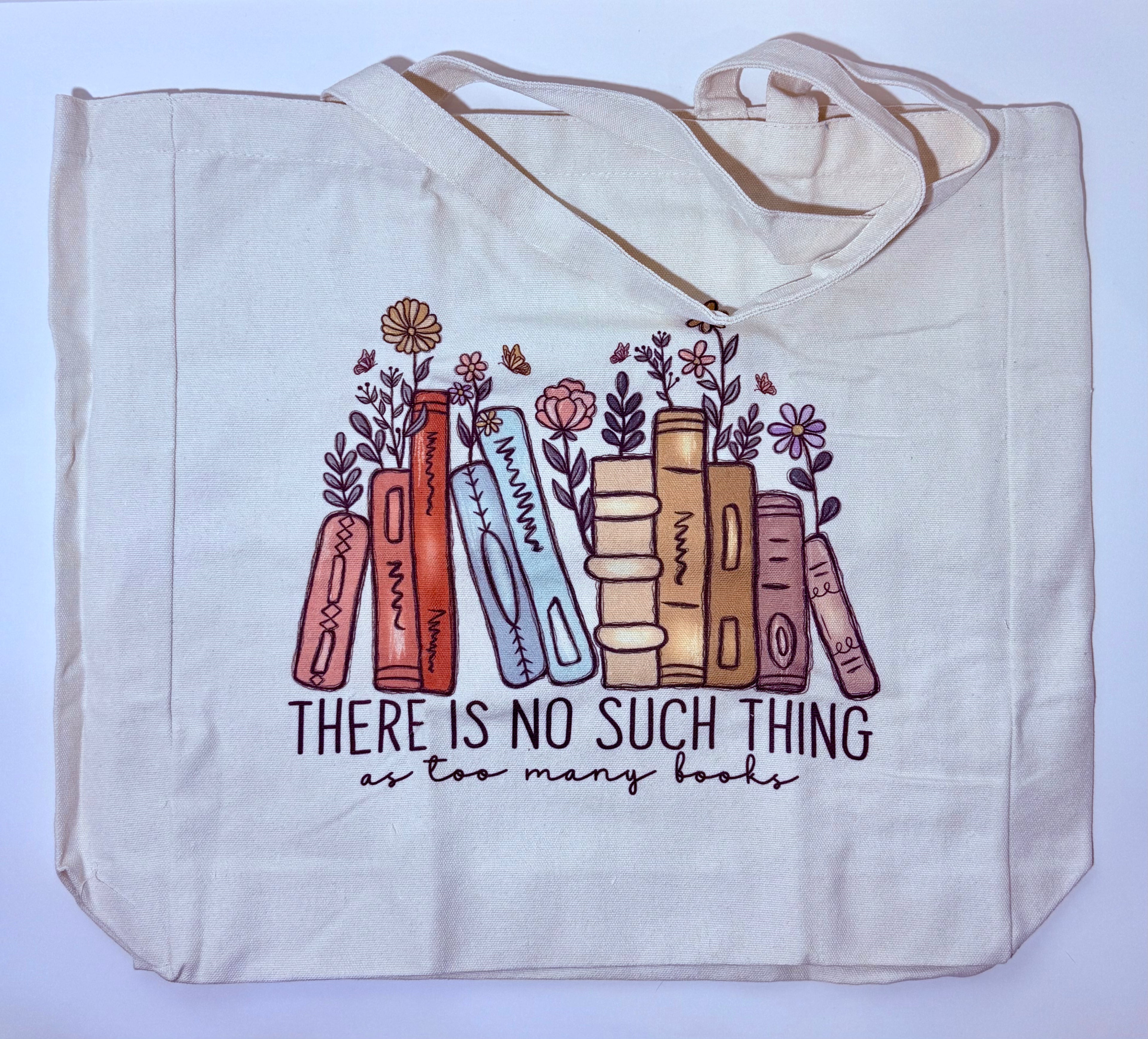 Tote bag with book and flower design and text on a light blue background
